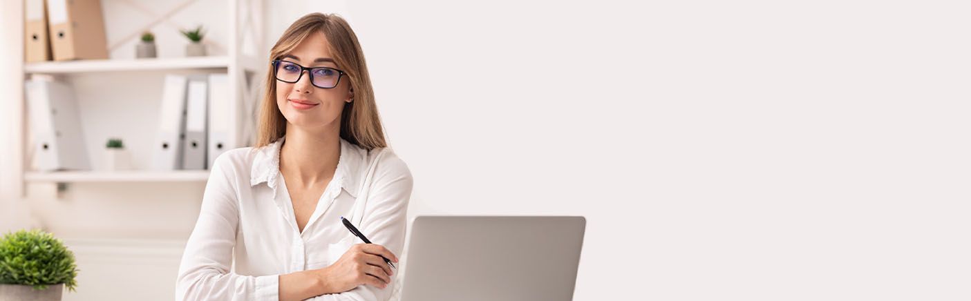 A compliance professional working at a laptop